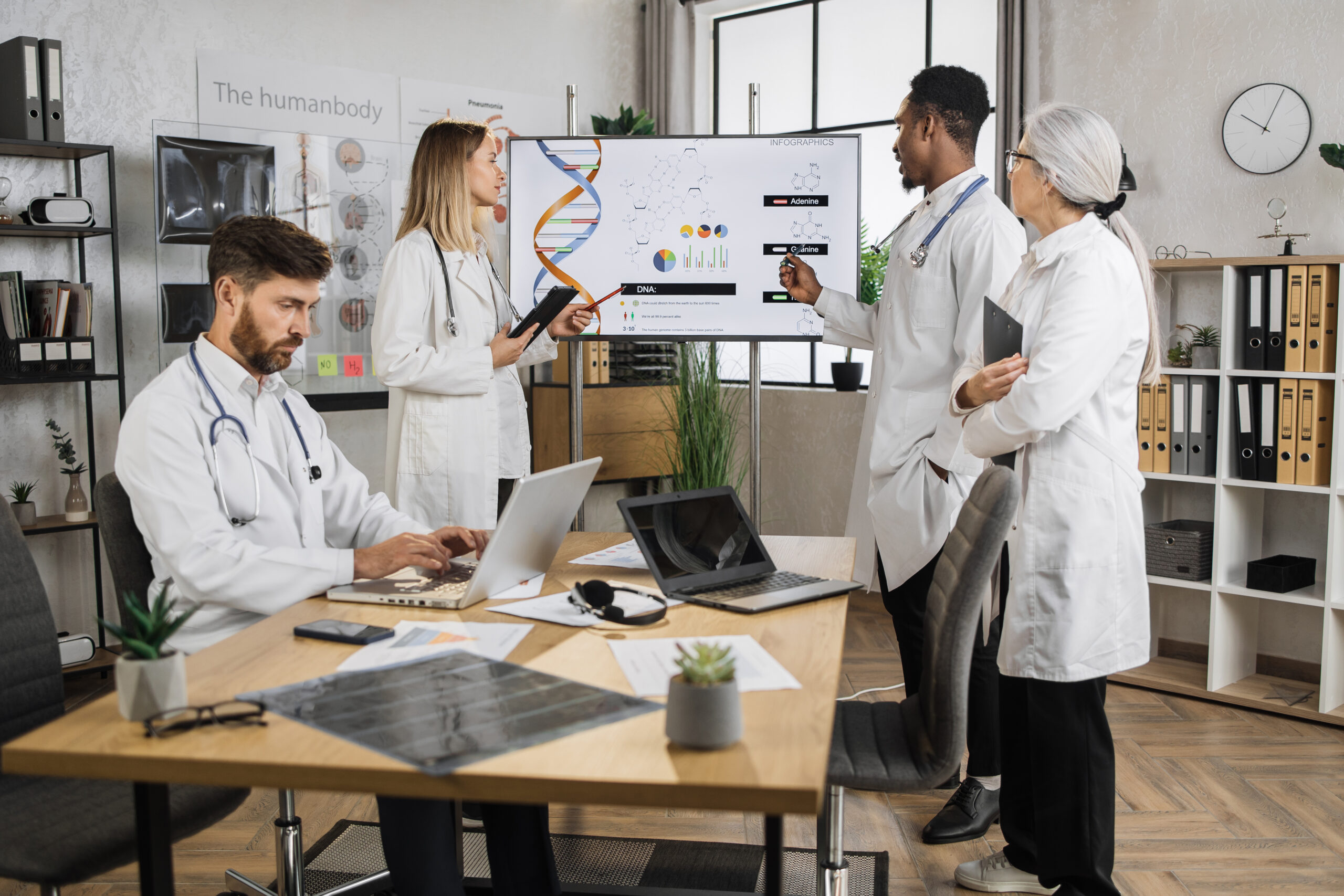 Doctors with laptop having sesion in lab boardroom